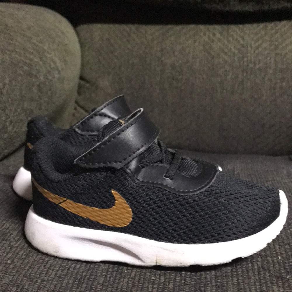 Black and gold Nike sneakers for toddlers